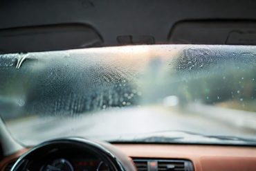 an image of a modern car windshield which has lots of condensation
