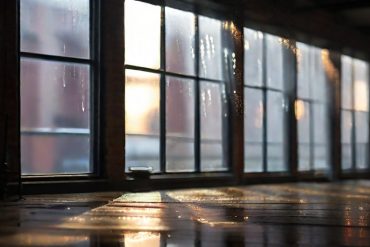 a loft space with visible condensation on the windows and ceiling